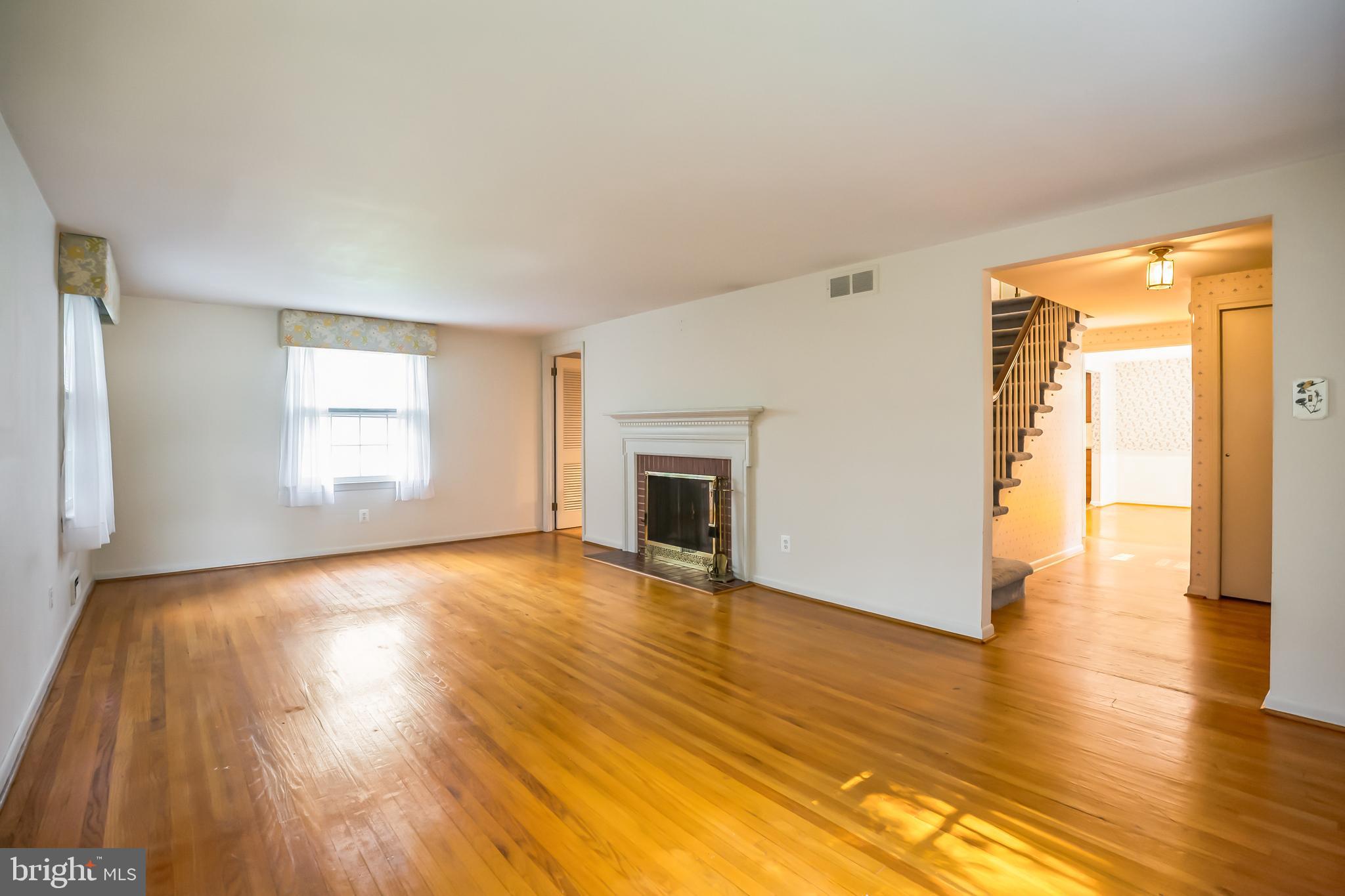 121 Rockingham Road Cherry Hill, NJ 08034 - Photo 5 of 33 a view of an empty room with wooden floor and a window