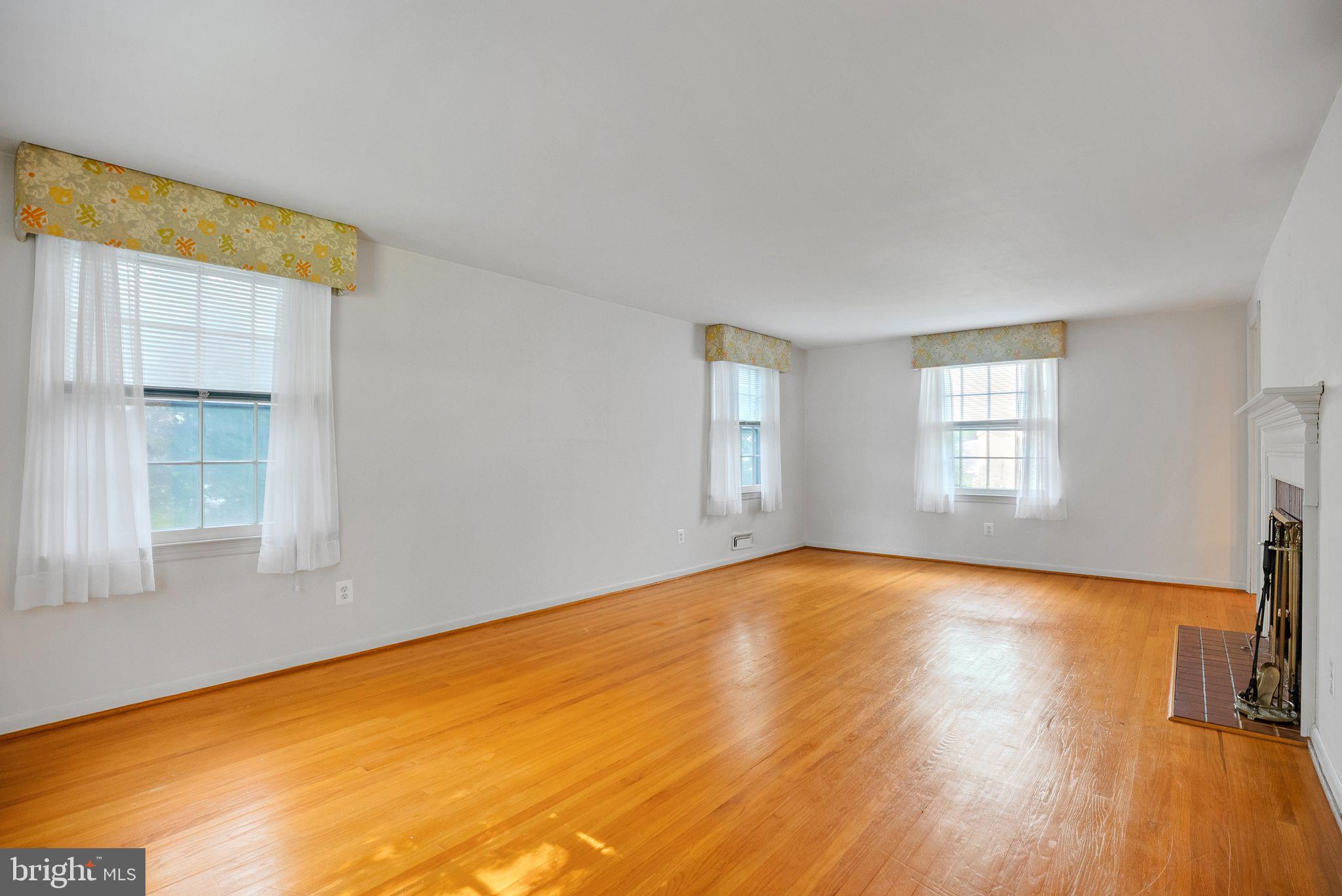 121 Rockingham Road Cherry Hill, NJ 08034 - Photo 7 of 33 a view of empty room with wooden floor and fan
