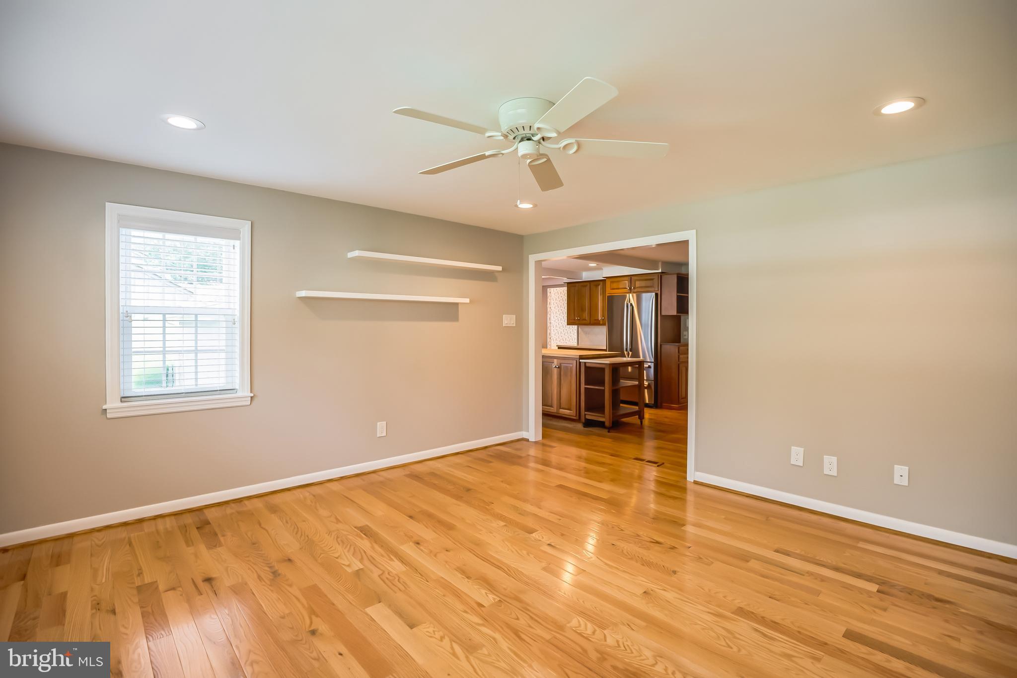121 Rockingham Road Cherry Hill, NJ 08034 - Photo 9 of 33 an empty room with wooden floor fan and windows