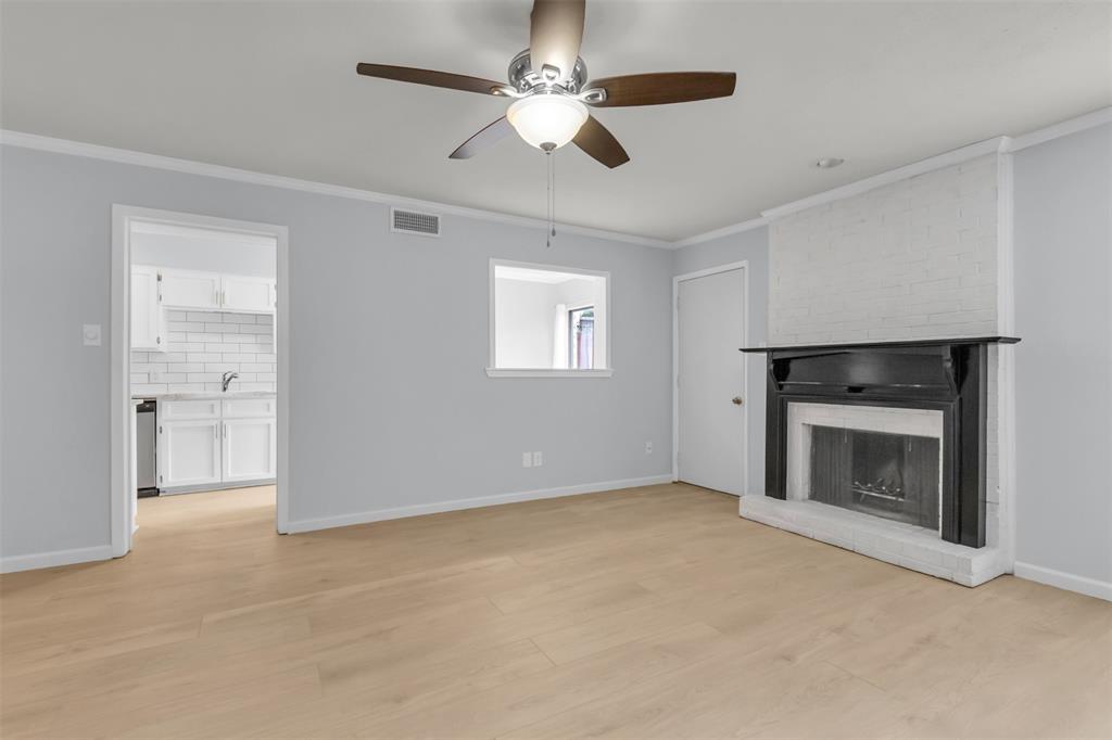 7610 Highmont Street Dallas, TX 75230 - Photo 12 of 37 an empty room with windows and fireplace