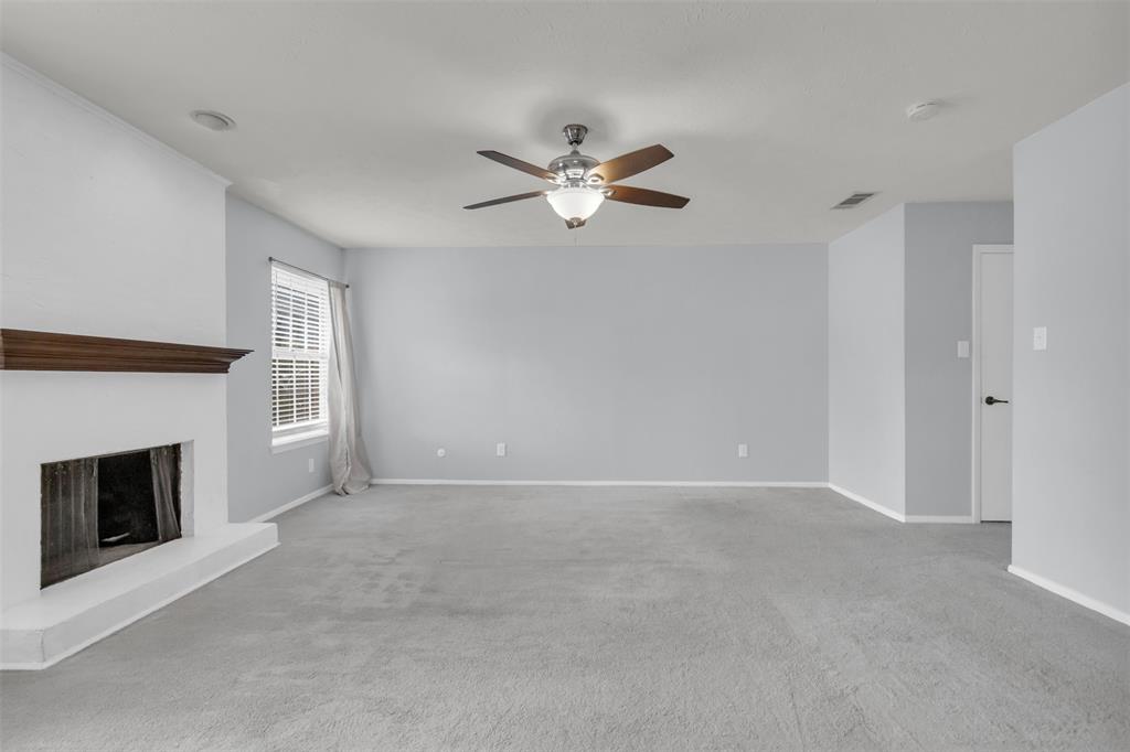 7610 Highmont Street Dallas, TX 75230 - Photo 26 of 37 a view of an empty room with a fireplace