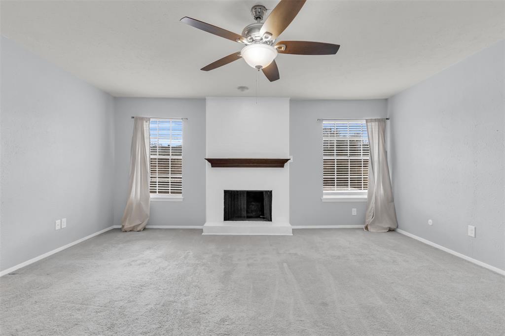 7610 Highmont Street Dallas, TX 75230 - Photo 27 of 37 an empty room with windows and fireplace
