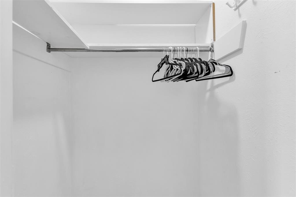 7610 Highmont Street Dallas, TX 75230 - Photo 30 of 37 a white wall with a close up view of a air conditioner and a window