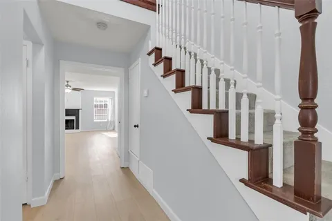 a view of staircase with lots of frames and a rug