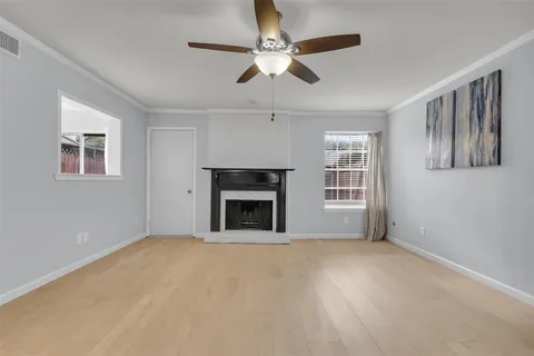 a view of an empty room with window and fireplace
