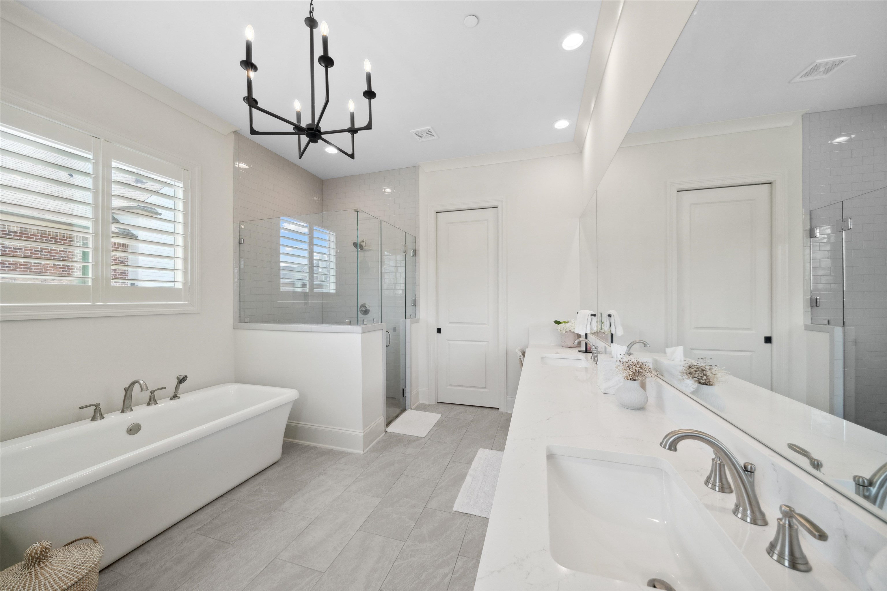 220 Mary Taylor Way Piperton, TN 38017 - Photo 16 of 36 Bathroom featuring double vanity, a stall shower, a freestanding bath, and suspended lighting