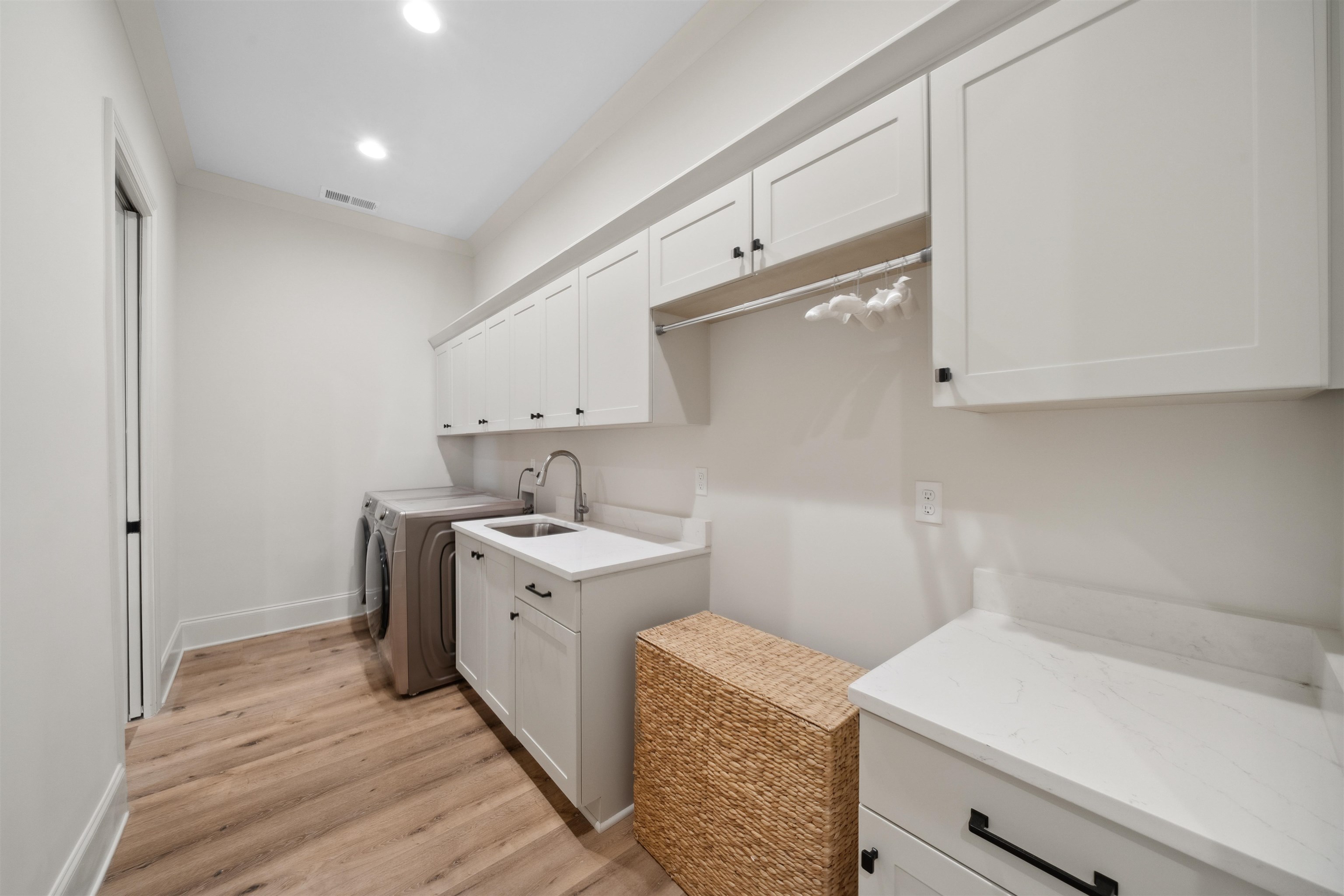 220 Mary Taylor Way Piperton, TN 38017 - Photo 18 of 36 Laundry room with cabinet space, light wood-style floors, recessed lighting, and washing machine and dryer