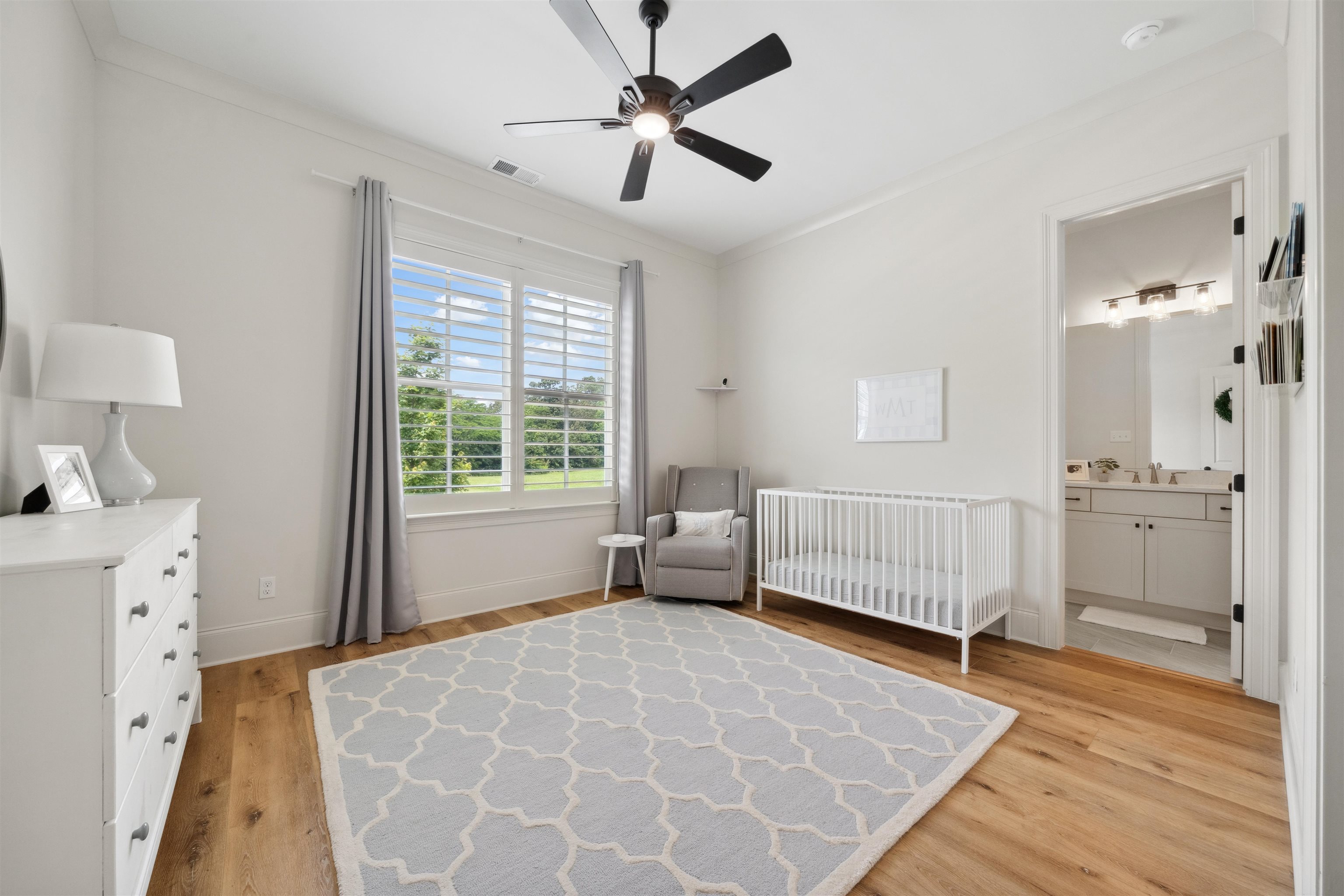220 Mary Taylor Way Piperton, TN 38017 - Photo 20 of 36 Bedroom featuring light wood finished floors, a ceiling fan, ornamental molding, and a nursery area