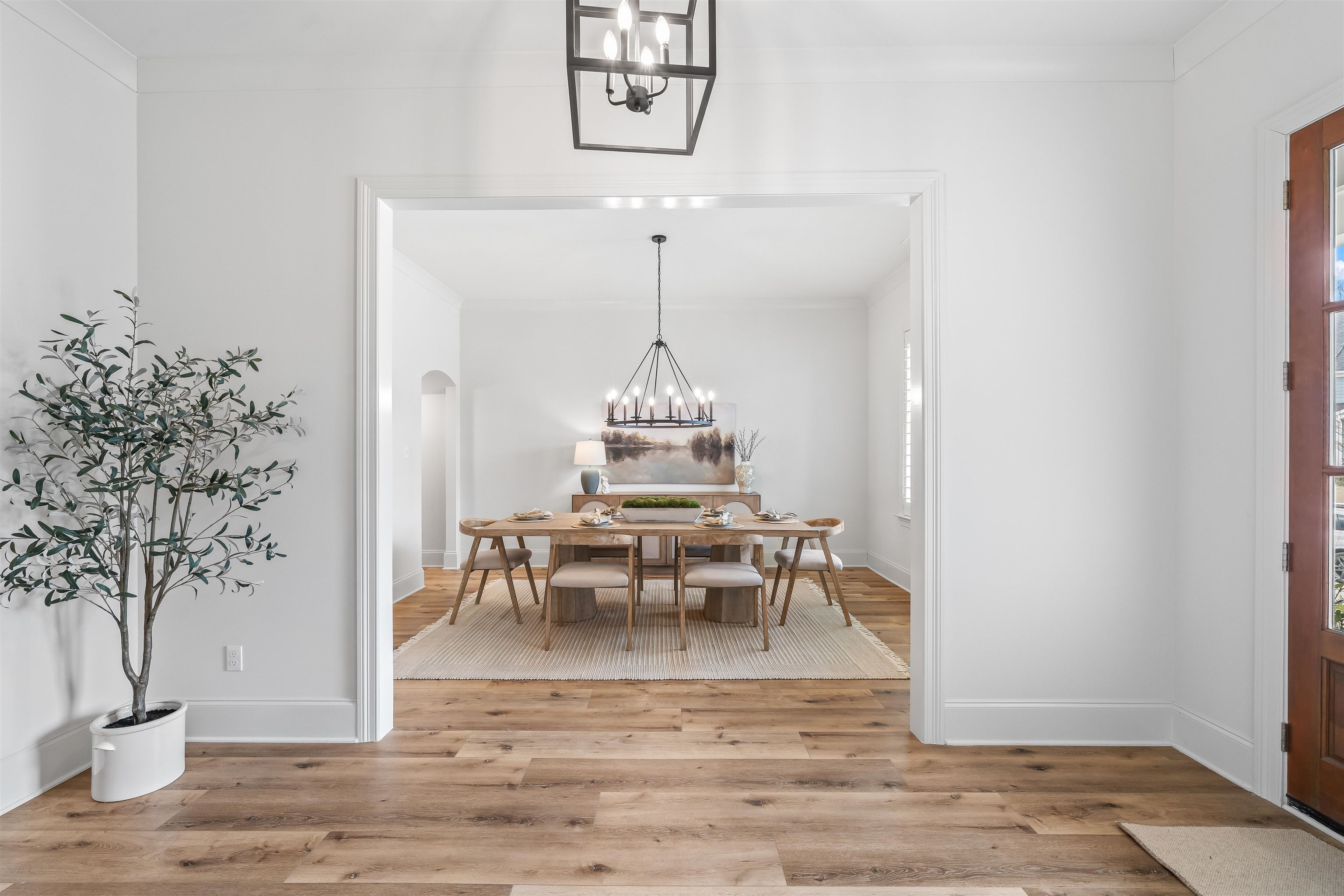 220 Mary Taylor Way Piperton, TN 38017 - Photo 5 of 36 Dining space featuring hanging lights, light wood-type flooring, arched walkways, and healthy amount of natural light