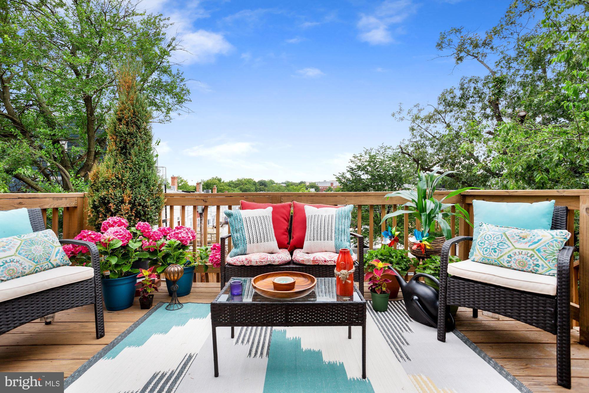 a outdoor living space with furniture and flowers