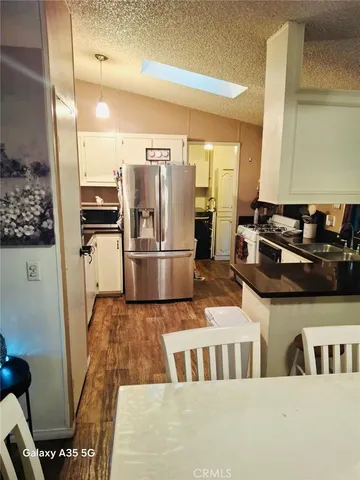 a kitchen with stainless steel appliances granite countertop a refrigerator and a stove