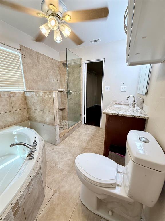 312 Ralph Street White Settlement, TX 76108 - Photo 24 of 32 Tiled shower with glass enclosure, separate soaking tub, and a dual-sink vanity with a light-colored countertop