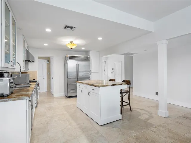 a view of a house with swimming pool and sitting area