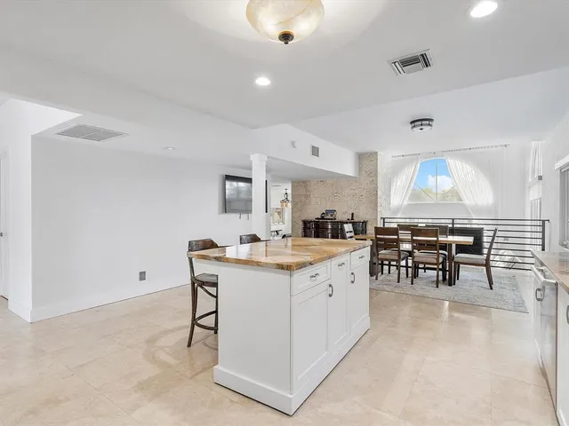 a front view of a house with large trees