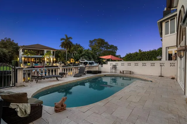a view of houses with swimming pool and sitting area