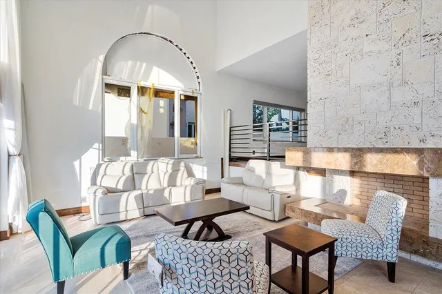 a bedroom with a bed chandelier and window