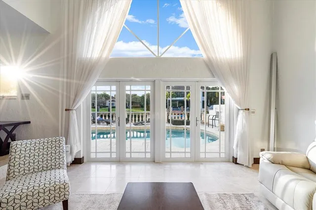 a view of a swimming pool with outdoor seating and plants