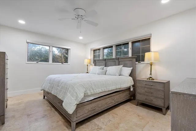 an aerial view of residential houses with outdoor space and trees