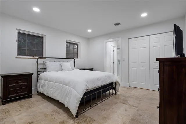 an aerial view of residential houses with outdoor space and trees