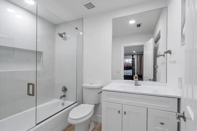 an aerial view of residential houses with outdoor space and parking