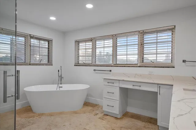 an aerial view of residential houses with outdoor space and parking