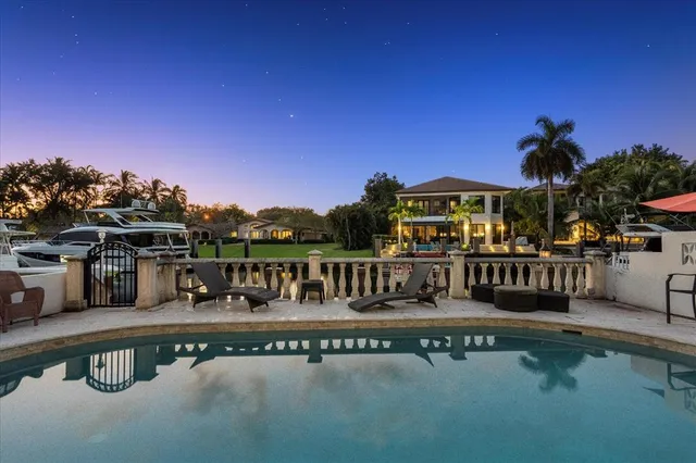 a view of a swimming pool with outdoor seating
