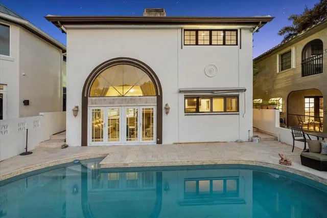 a view of houses with swimming pool and sitting area