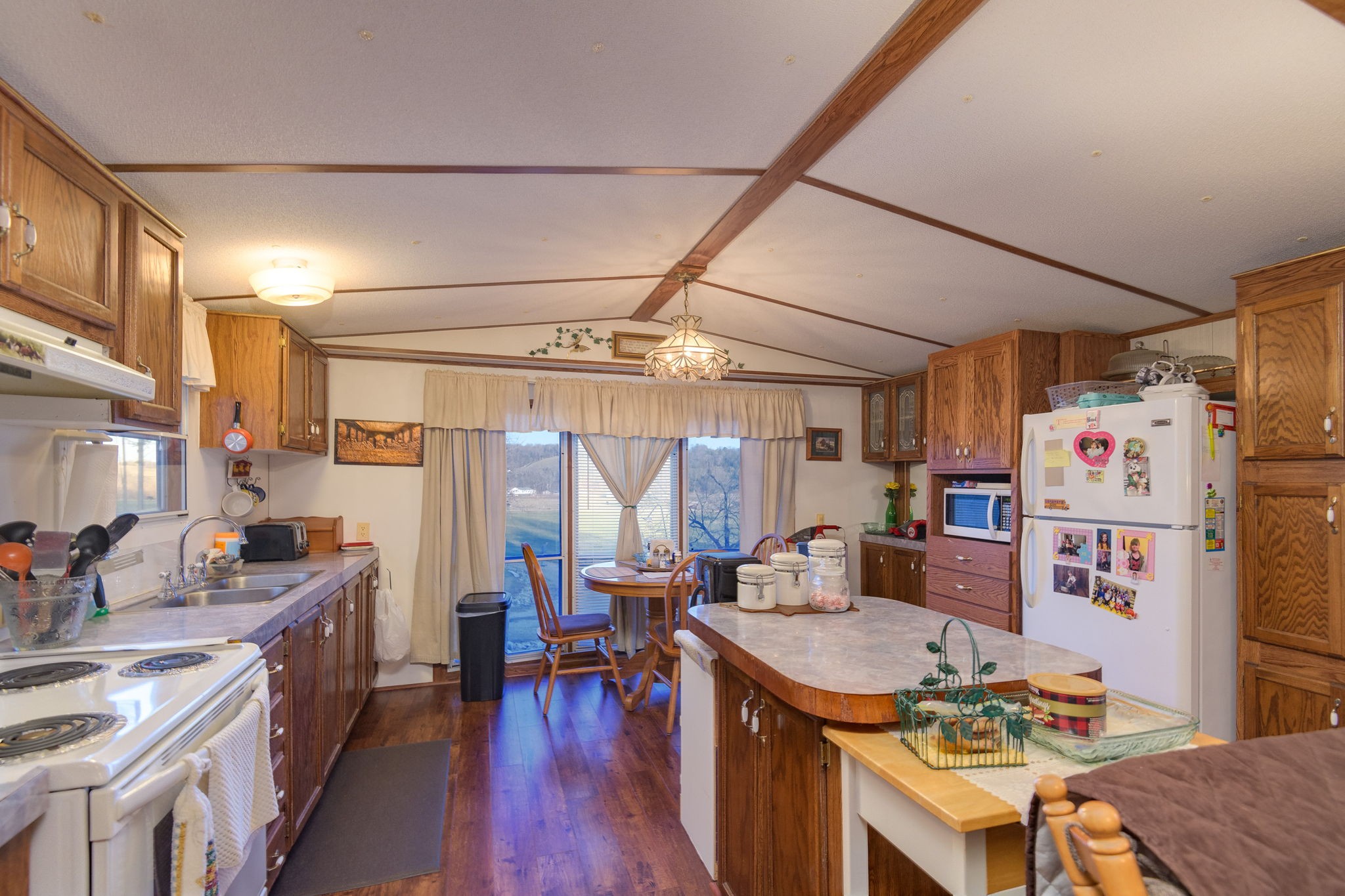 7925 Tom Patton Road Lyles, TN 37098 - Photo 50 of 68 a kitchen with a stove a refrigerator and a dining table