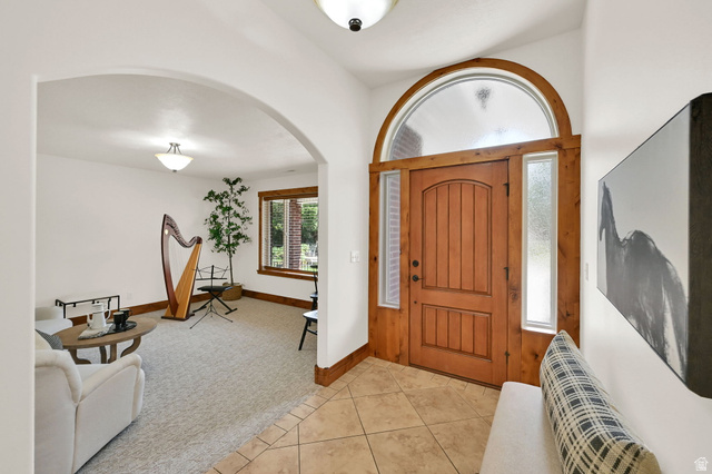 13658 South Fort Street Draper, UT 84020 - Photo 9 of 87 Arch-top wooden entry door with a frosted glass transom and sidelights