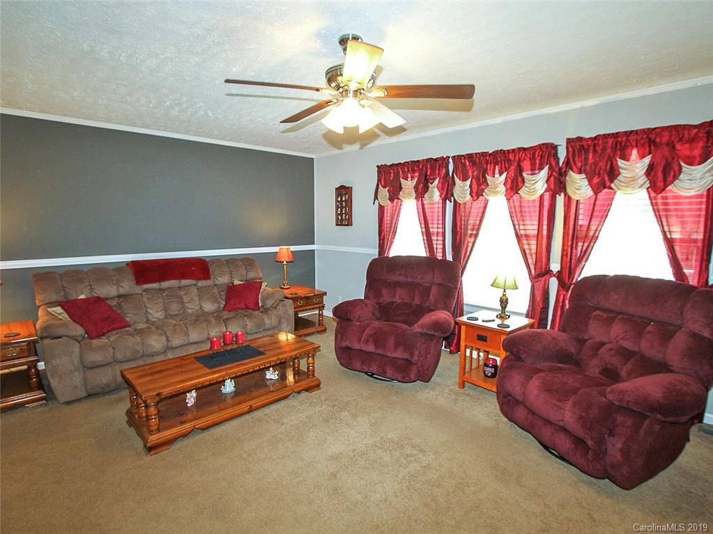 4027 Pink Plyler Road Lancaster, SC 29720 - Photo 16 of 34 a bedroom with furniture and a chandelier