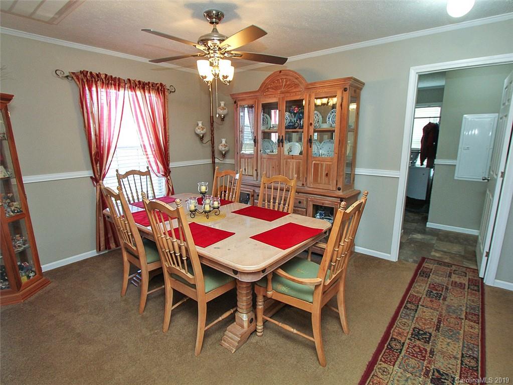 4027 Pink Plyler Road Lancaster, SC 29720 - Photo 29 of 34 a dining room with furniture a chandelier and window