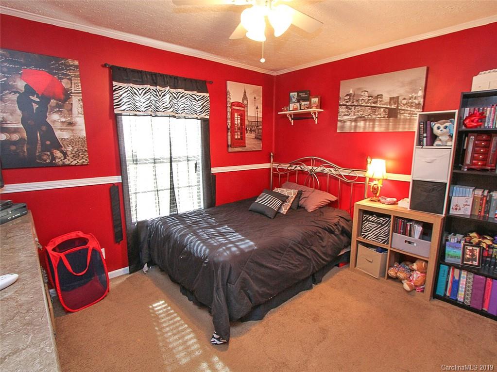 4027 Pink Plyler Road Lancaster, SC 29720 - Photo 30 of 34 a bedroom with a bed and a bookshelf