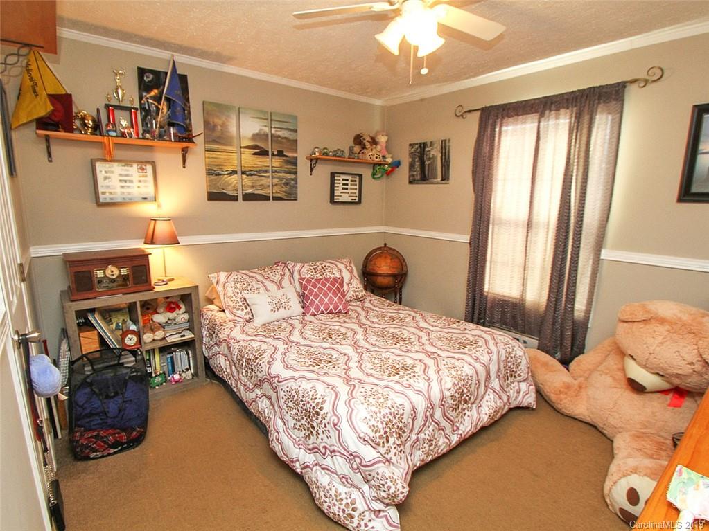 4027 Pink Plyler Road Lancaster, SC 29720 - Photo 32 of 34 a bedroom with a bed and cabinets