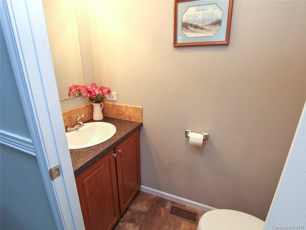 4027 Pink Plyler Road Lancaster, SC 29720 - Photo 33 of 34 a bathroom with a sink vanity mirror and toilet