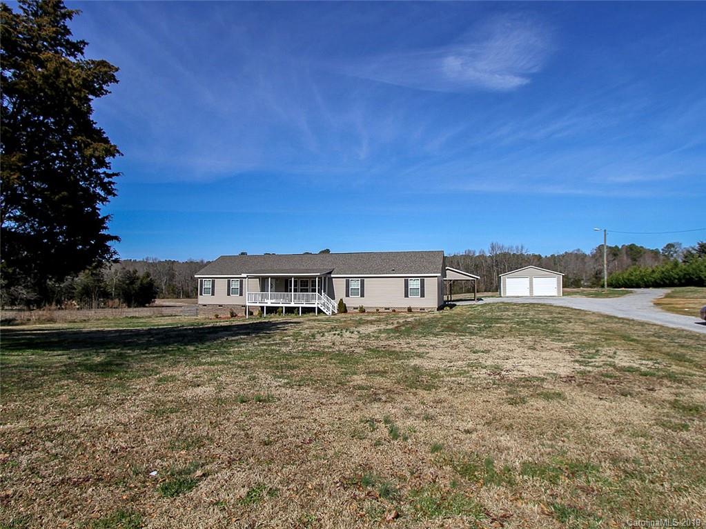 4027 Pink Plyler Road Lancaster, SC 29720 - Photo 6 of 34 a view of a big house with a big yard and large trees