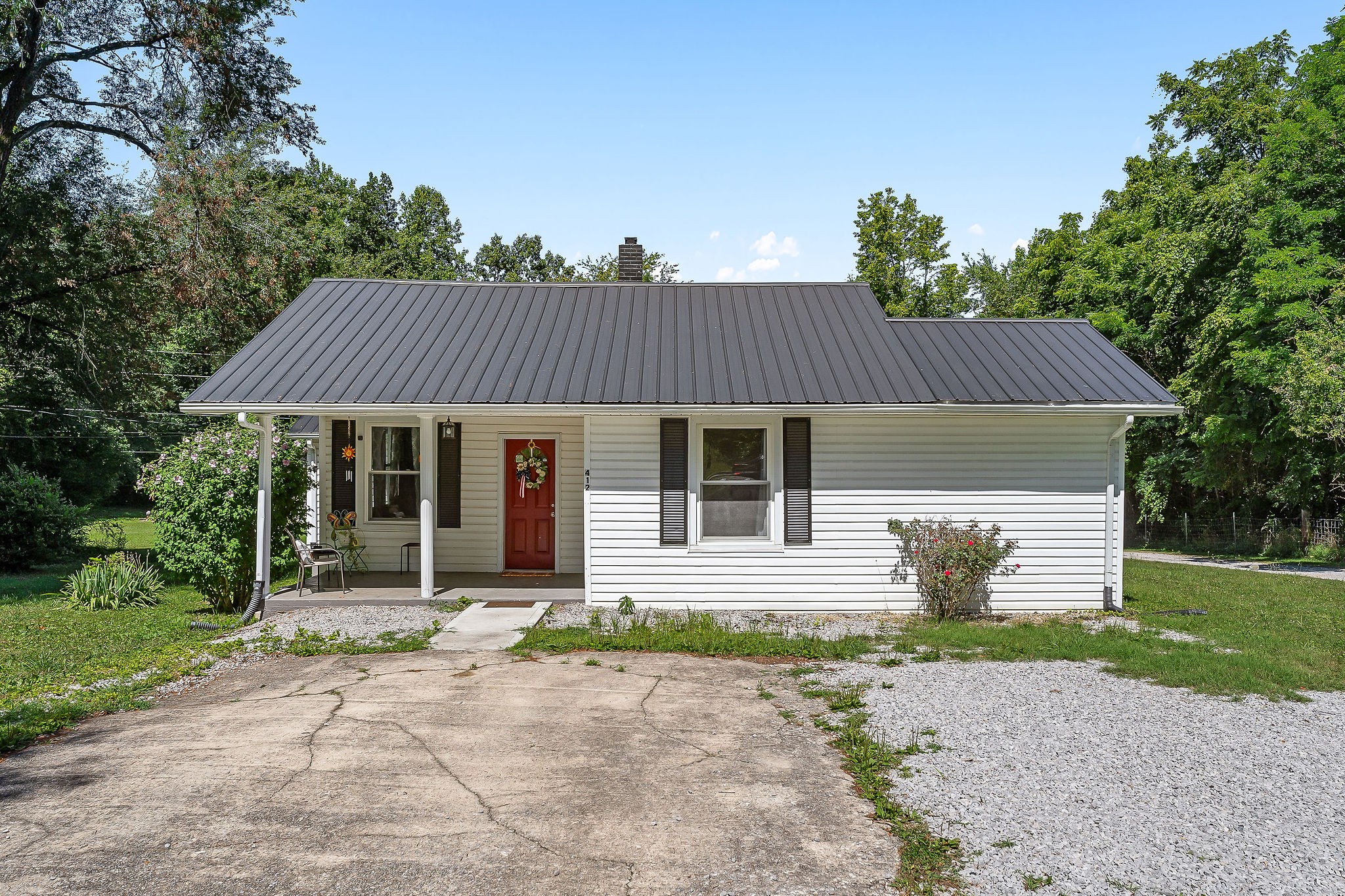 412 3rd Avenue North Baxter, TN 38544 - Photo 1 of 32 a front view of a house with garden