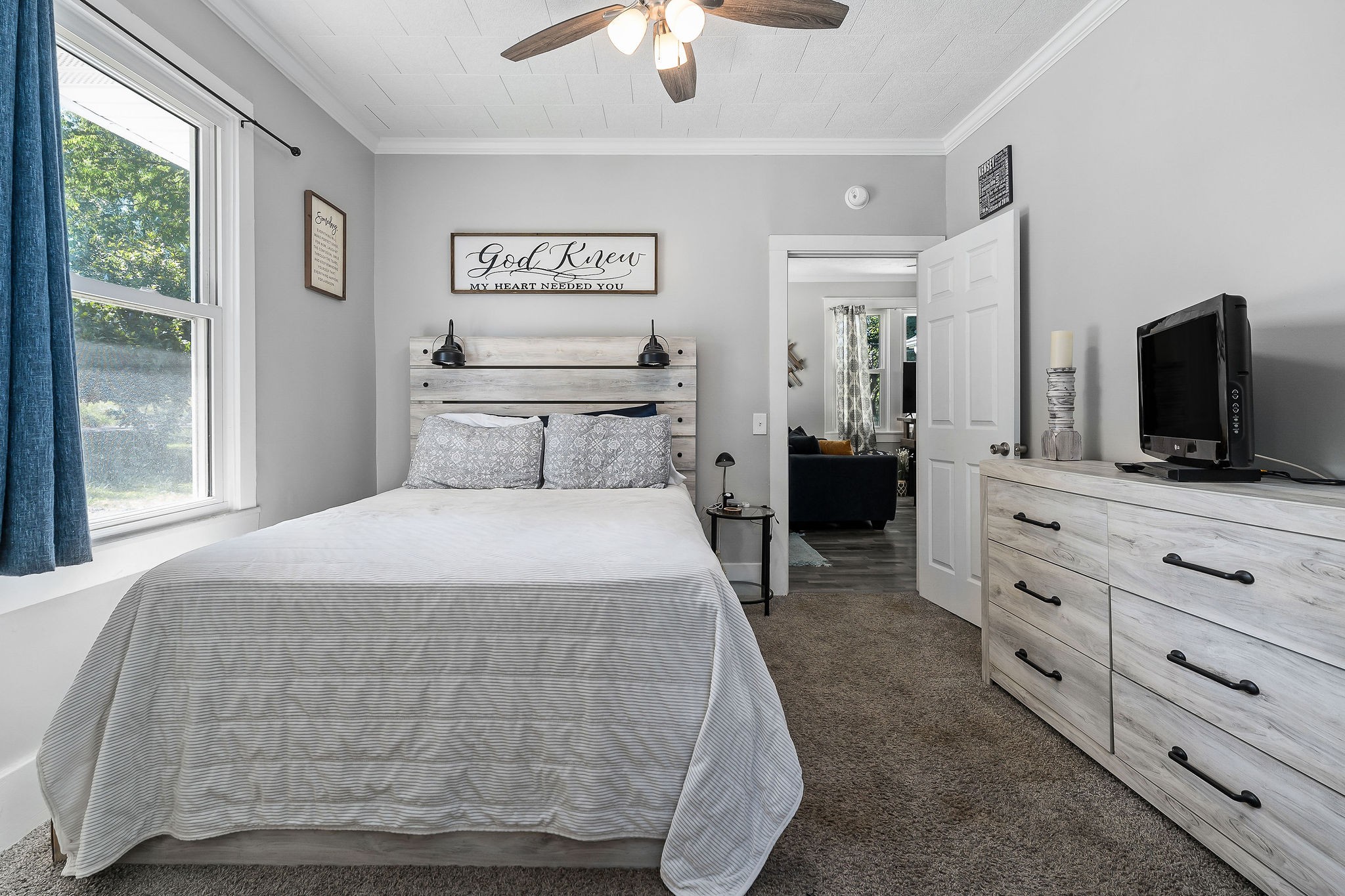 412 3rd Avenue North Baxter, TN 38544 - Photo 24 of 32 a bedroom with a large bed and flat tv screen on dresser