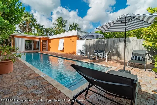 swimming pool view with a seating space