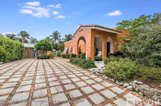 a kitchen with granite countertop a sink and a refrigerator
