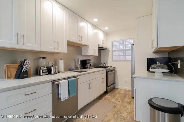 a bedroom with a bed a dresser and a large window