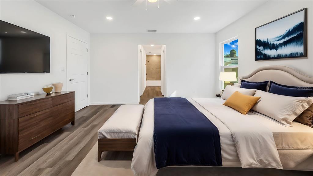 1040 20th Street Orlando, FL 32805 - Photo 14 of 33 a bedroom with a bed and a flat screen tv