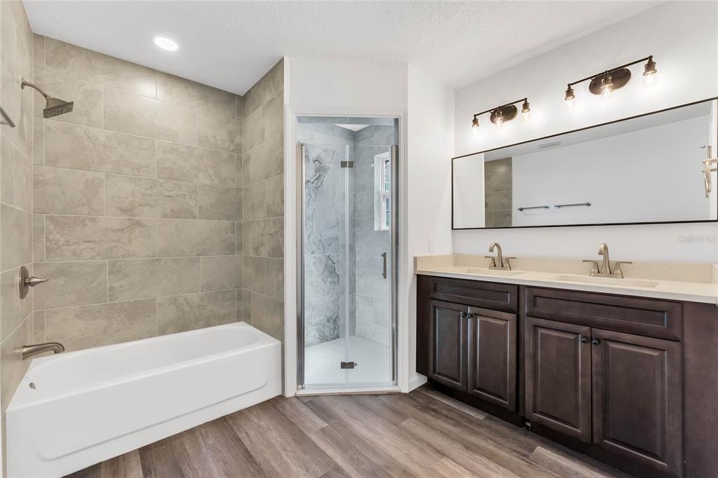 1040 20th Street Orlando, FL 32805 - Photo 16 of 33 a bathroom with a tub sink shower and mirror