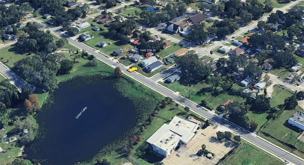 1040 20th Street Orlando, FL 32805 - Photo 28 of 33 an aerial view of a house a yard and a pond