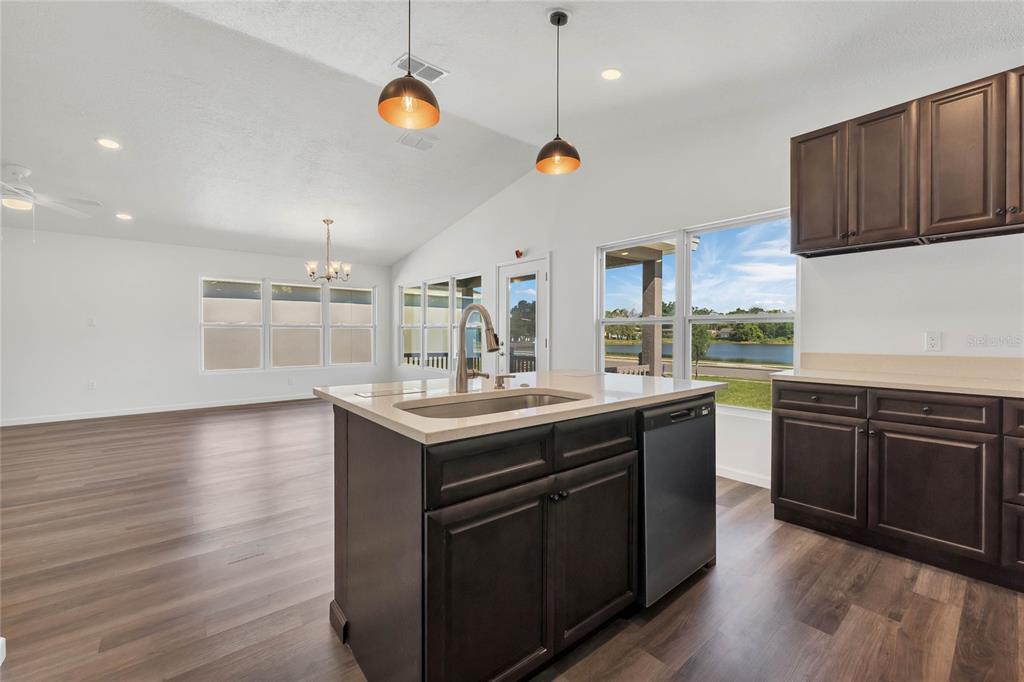 1040 20th Street Orlando, FL 32805 - Photo 8 of 33 a kitchen with stainless steel appliances granite countertop a sink a stove a refrigerator and wooden floor