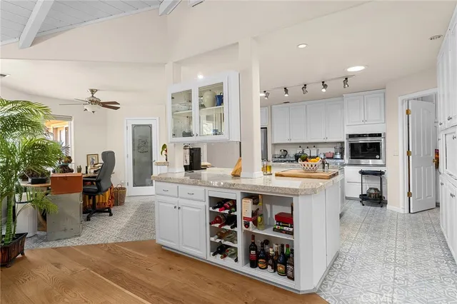 a kitchen with stove a sink and cabinets