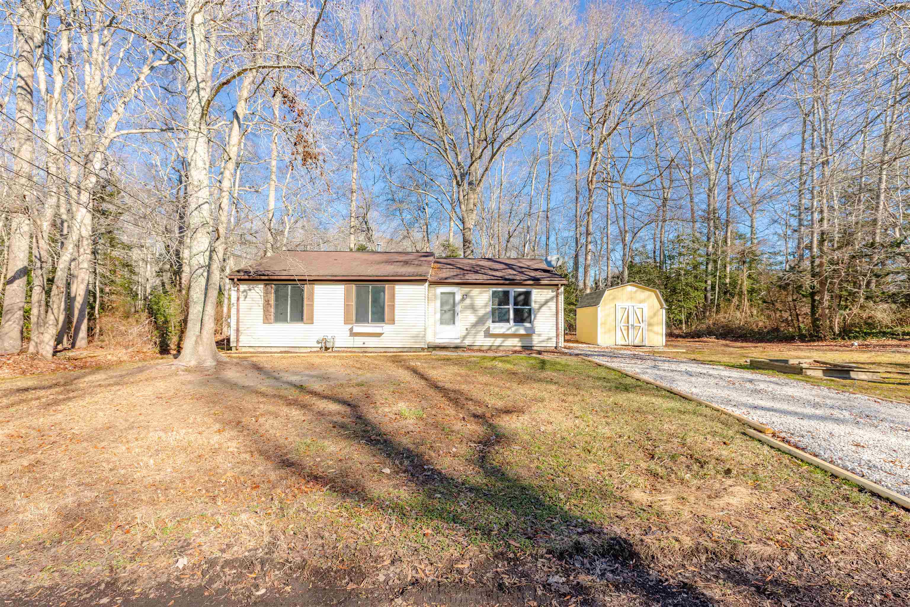 a view of a house with snow on the road