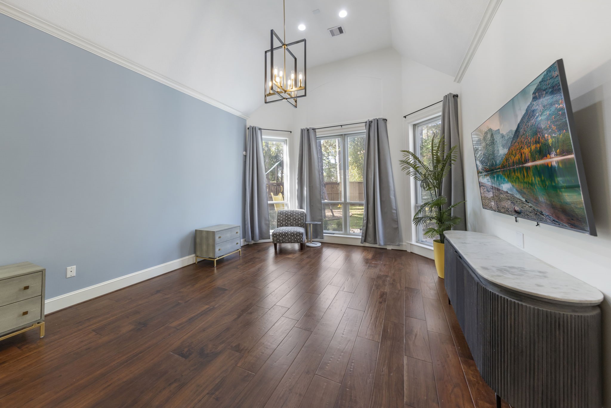 90 West Horizon Ridge Place Spring, TX 77381 - Photo 8 of 36 a view of an empty room with wooden floor and a window