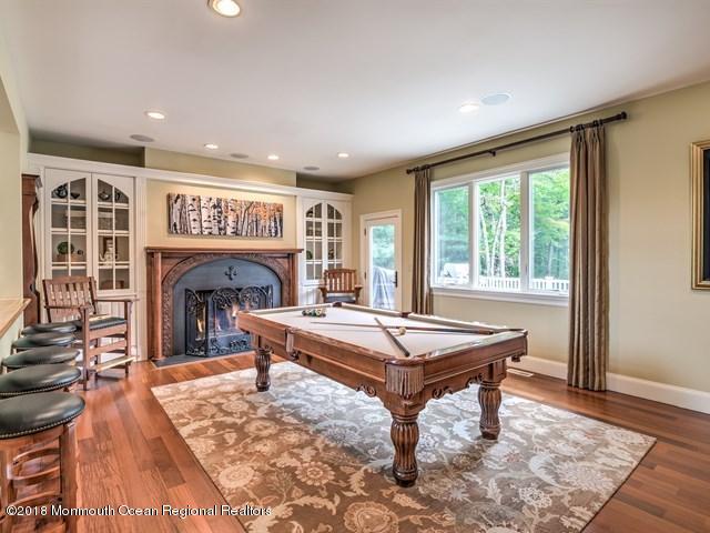 19 Russell Road Freehold, NJ 07728 - Photo 12 of 68 a living room with furniture a table and a fireplace