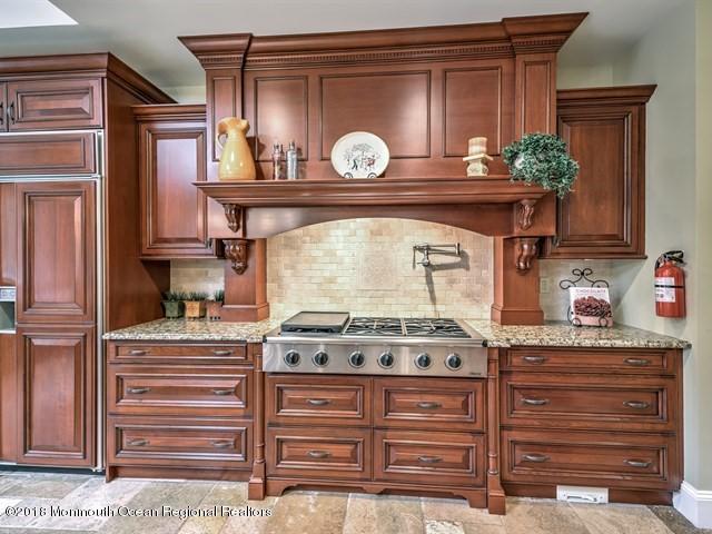 19 Russell Road Freehold, NJ 07728 - Photo 17 of 68 a kitchen with granite countertop a stove and cabinets