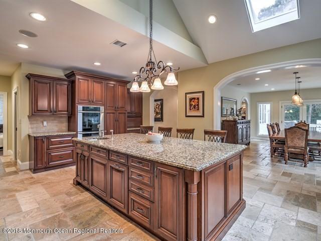 19 Russell Road Freehold, NJ 07728 - Photo 18 of 68 a kitchen with center island table and chairs in it